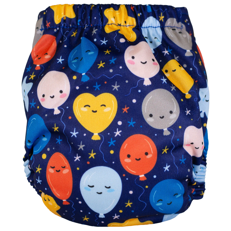 Tiny Tushies Newborn AIO cloth diaper with colorful balloon print on blue background.