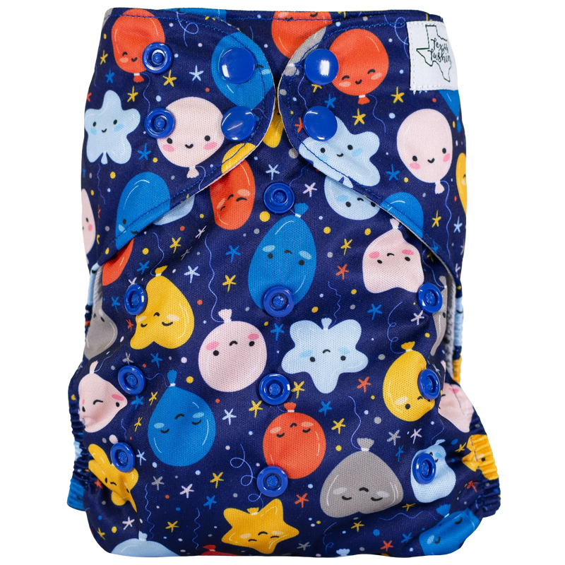 Colorful slim fit pocket cloth diaper with playful printed design and adjustable snaps.