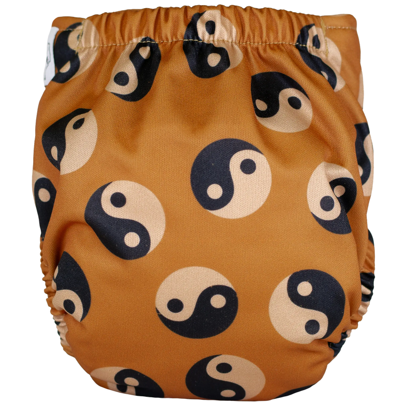 Tiny Tushies Newborn AIO Cloth Diaper with yin-yang pattern, adjustable fit for 5-20 lbs.