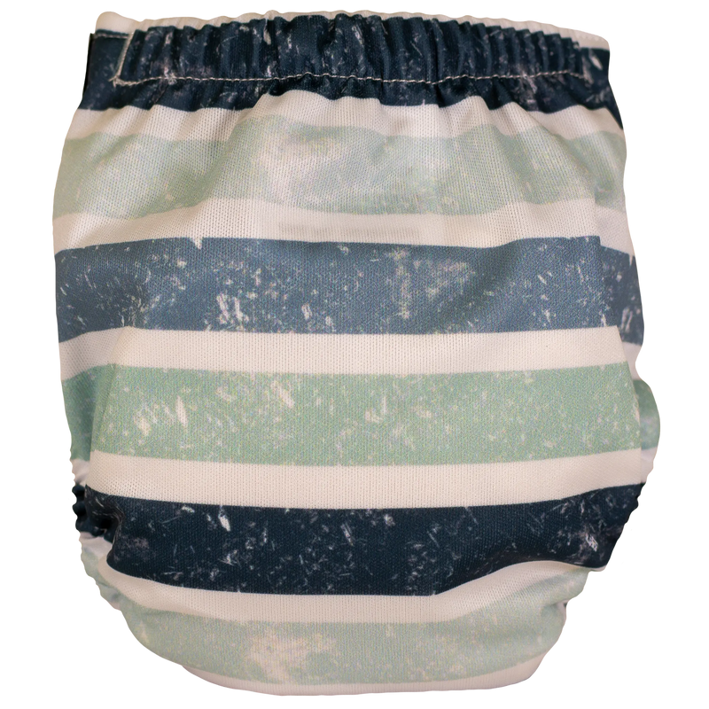 Tiny Tushies Newborn AIO Cloth Diaper with striped design, suitable for 5-20 lbs babies.