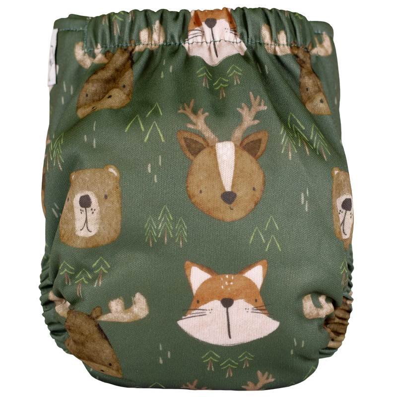 Tiny Tushies Newborn AIO Cloth Diaper with woodland animal print design on green background.