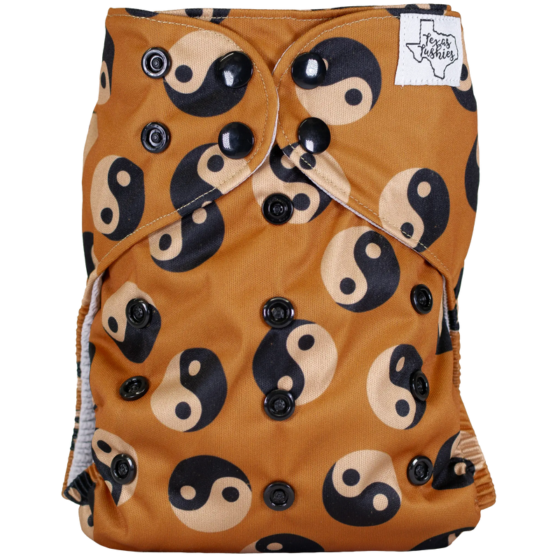 Slim Fit AIO Cloth Diaper with yin-yang pattern design, featuring adjustable snaps and a moisture-wicking jersey edge.