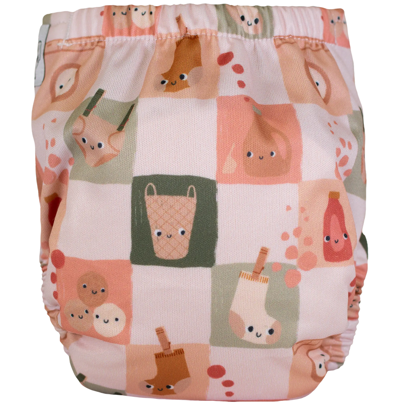 Tiny Tushies Newborn AIO Cloth Diaper with playful print, adjustable fit.