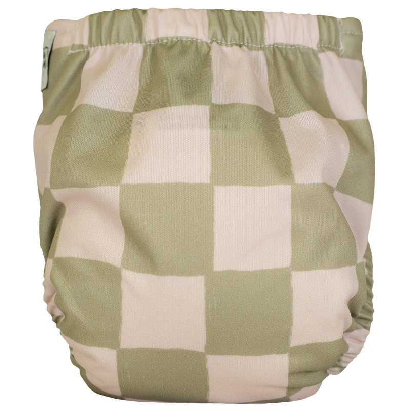 Tiny Tushies Newborn AIO Cloth Diaper with checkered print, suitable for 5-20 lbs, featuring pocket opening and recycled PUL material.