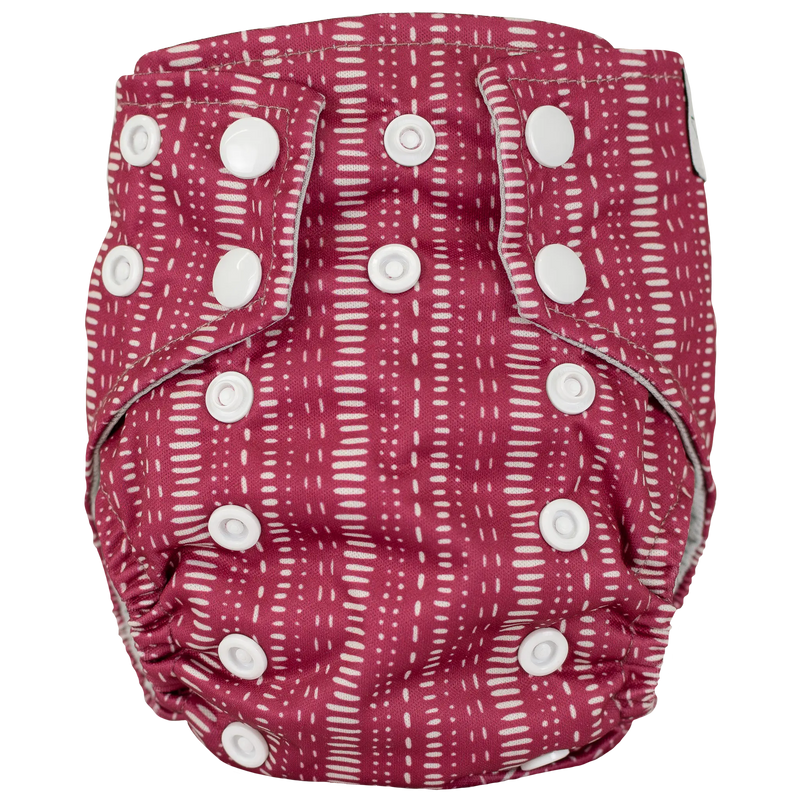 Tiny Tushies Newborn AIO Cloth Diaper with adjustable snaps and red pattern.