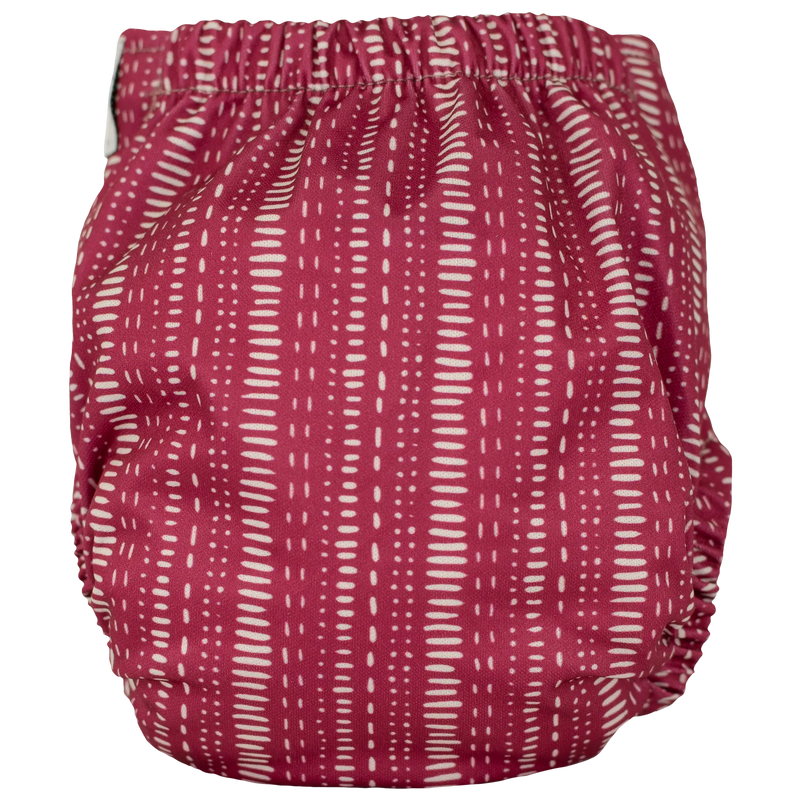 Tiny Tushies Newborn AIO Cloth Diaper with red and white pattern.