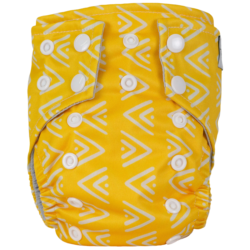 Tiny Tushies Newborn AIO Cloth Diaper in yellow with chevron pattern and white snaps.