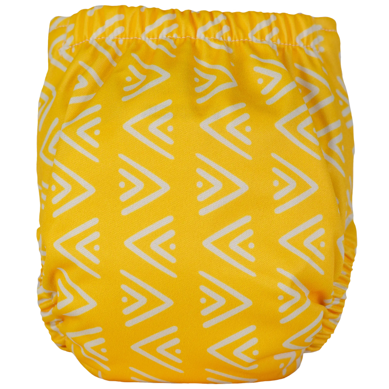 Tiny Tushies Newborn AIO Cloth Diaper with yellow geometric pattern.