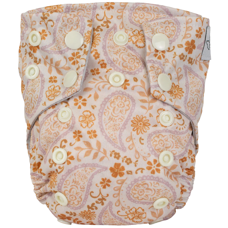Tiny Tushies Newborn AIO cloth diaper with floral pattern and snaps for secure fit.