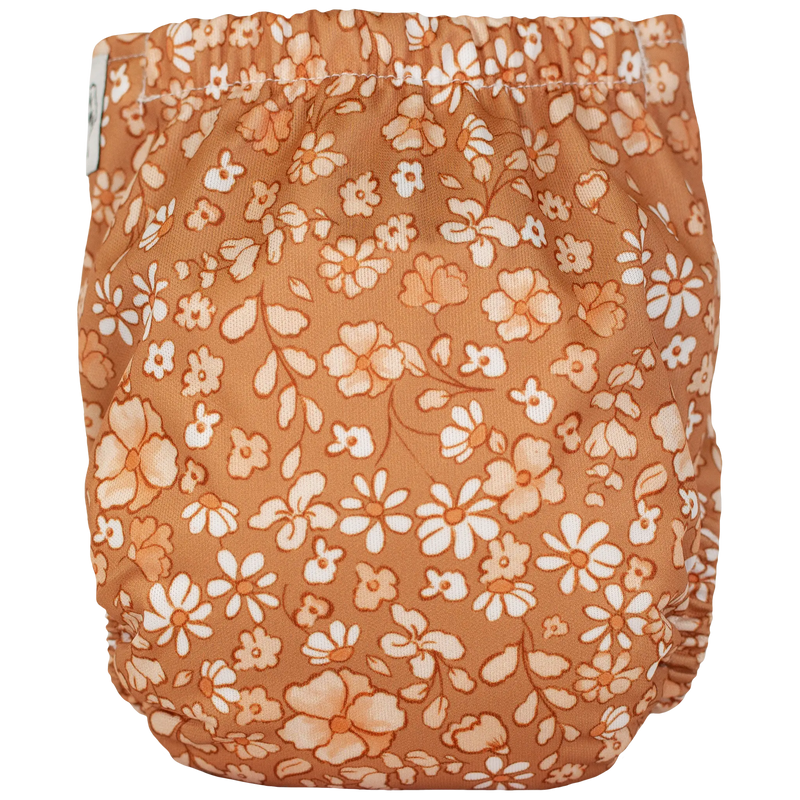 Tiny Tushies Newborn AIO Cloth Diaper with floral print, designed for babies 5-20 lbs.