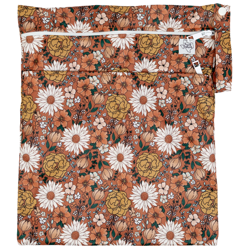 Texas Tushies Wet/Dry Bag with floral design, dual compartments, and zipper closure, 12x16 inches.