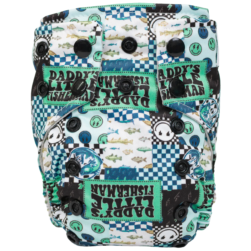 Tiny Tushies Newborn AIO Cloth Diaper with fish print and snaps for secure closure.