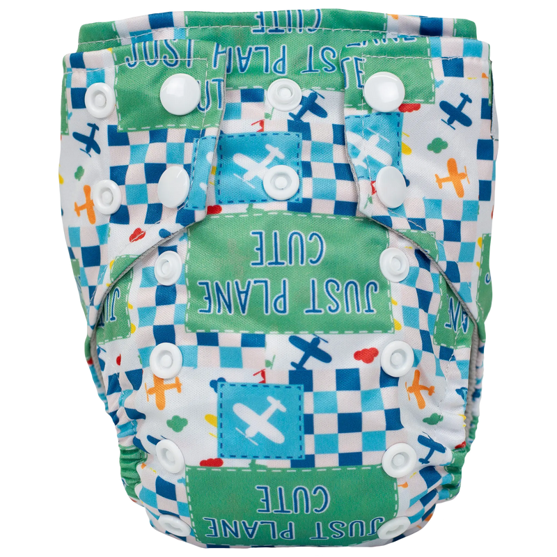 Tiny Tushies Newborn AIO Cloth Diaper with vibrant airplane print and secure closure snaps.