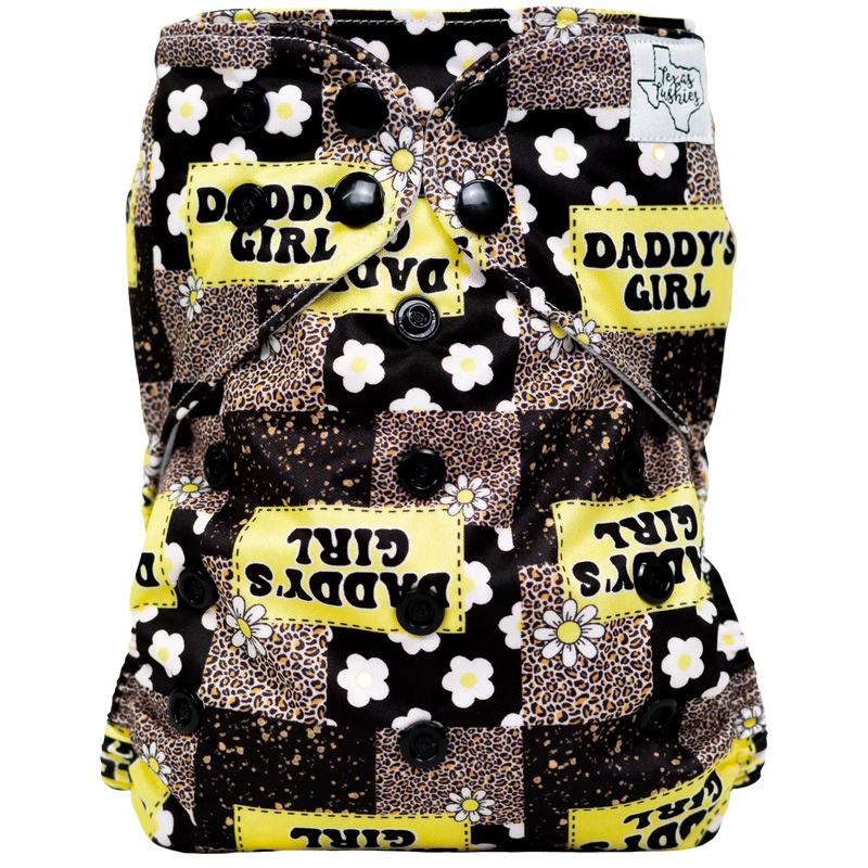 Slim Fit AIO Cloth Diaper with yellow and black "Daddy's Girl" print, featuring adjustable snaps and athletic wicking jersey material.