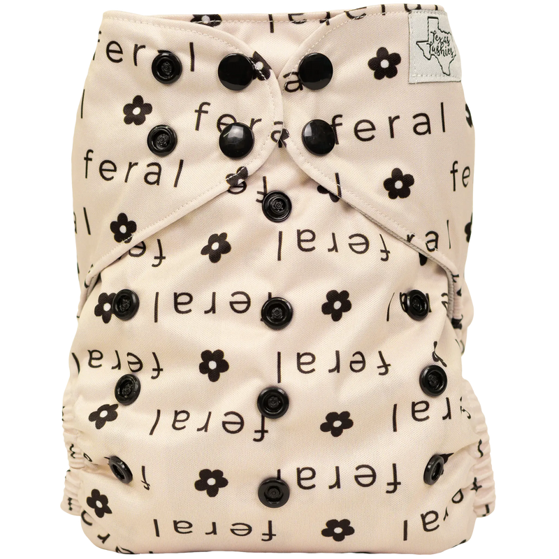 Slim Fit AIO Cloth Diaper with black floral and text design, features adjustable snaps for a customized fit.