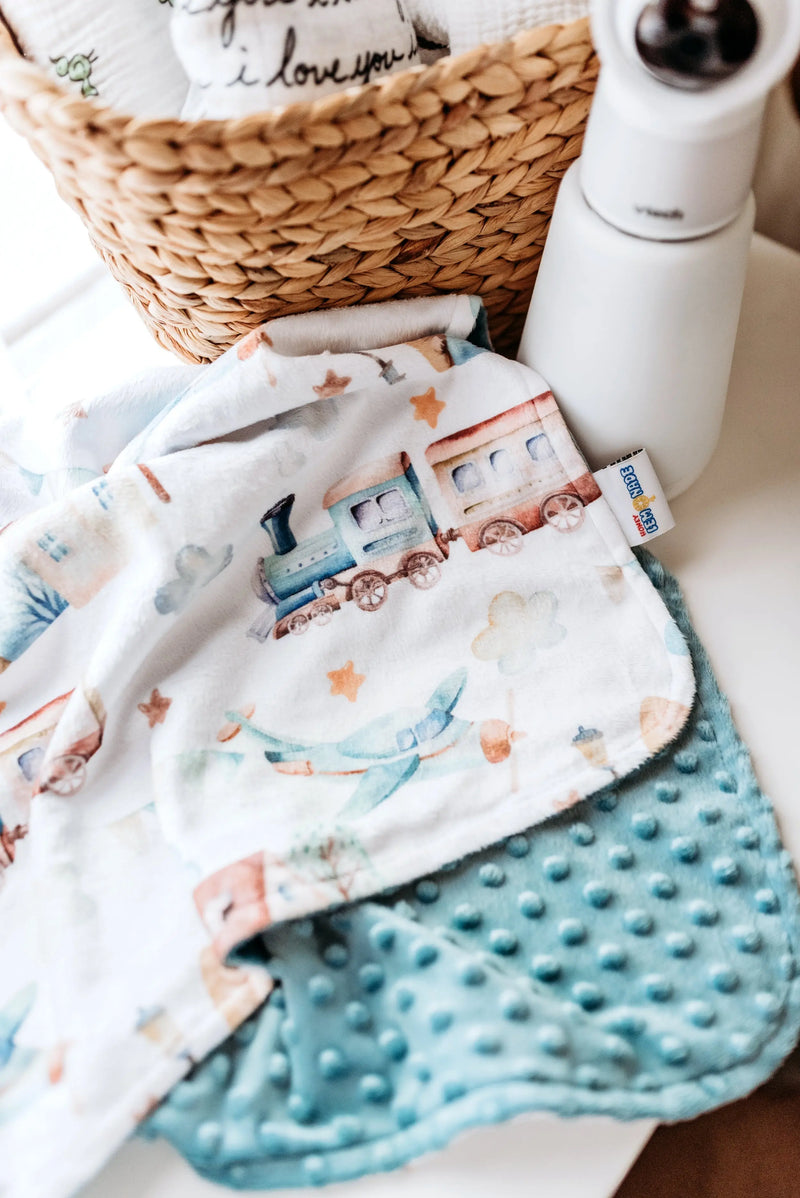 Premium baby & toddler minky blanket with planes, trains, and automobiles pattern; super soft and lightweight for travel.