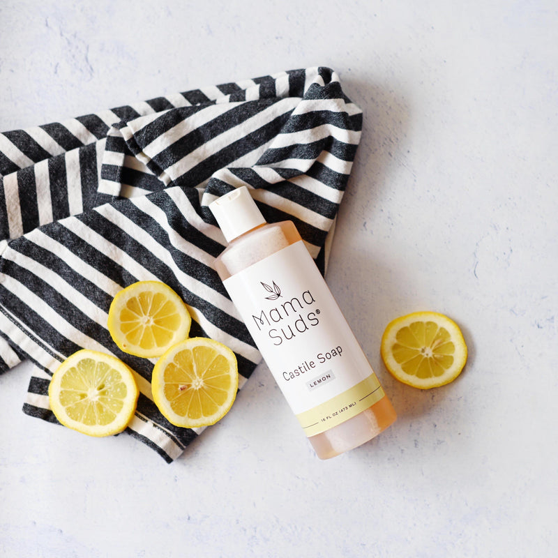 MamaSuds Castile Liquid Soap with lemon slices and striped towel.