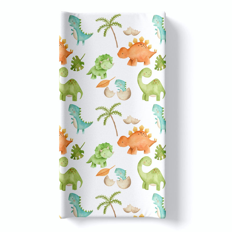 Changing pad cover with colorful dinosaur print, soft and stretchy fabric, fits most pads.