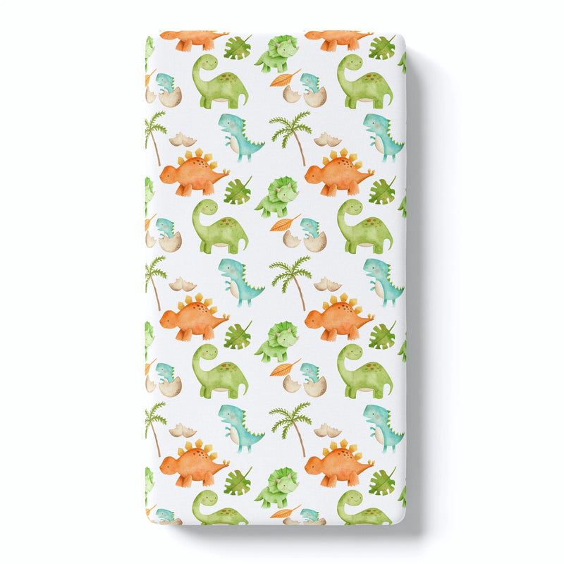 Fitted crib sheet with dinosaur pattern, soft fabric, ideal for baby photos.