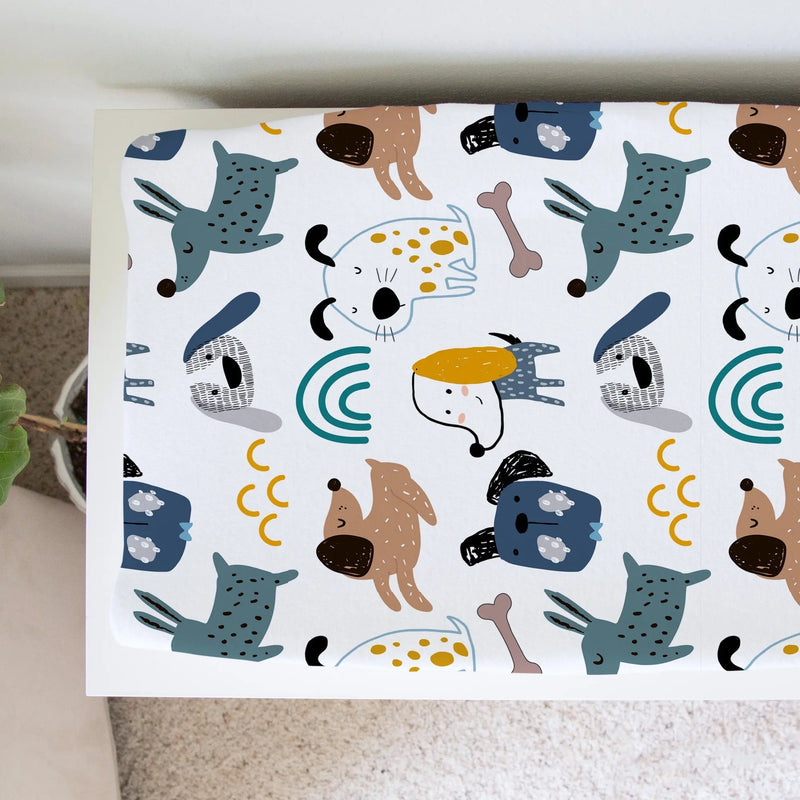 Changing pad cover with playful dog pattern, soft fabric, fits most pads.