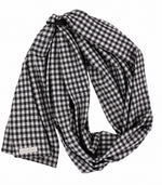 Black and white gingham ring sling baby carrier with black aluminum rings and long fabric tail