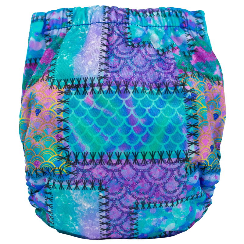 Tiny Tushies Newborn AIO Cloth Diaper with colorful pattern and adjustable fit for 5-20 lbs.