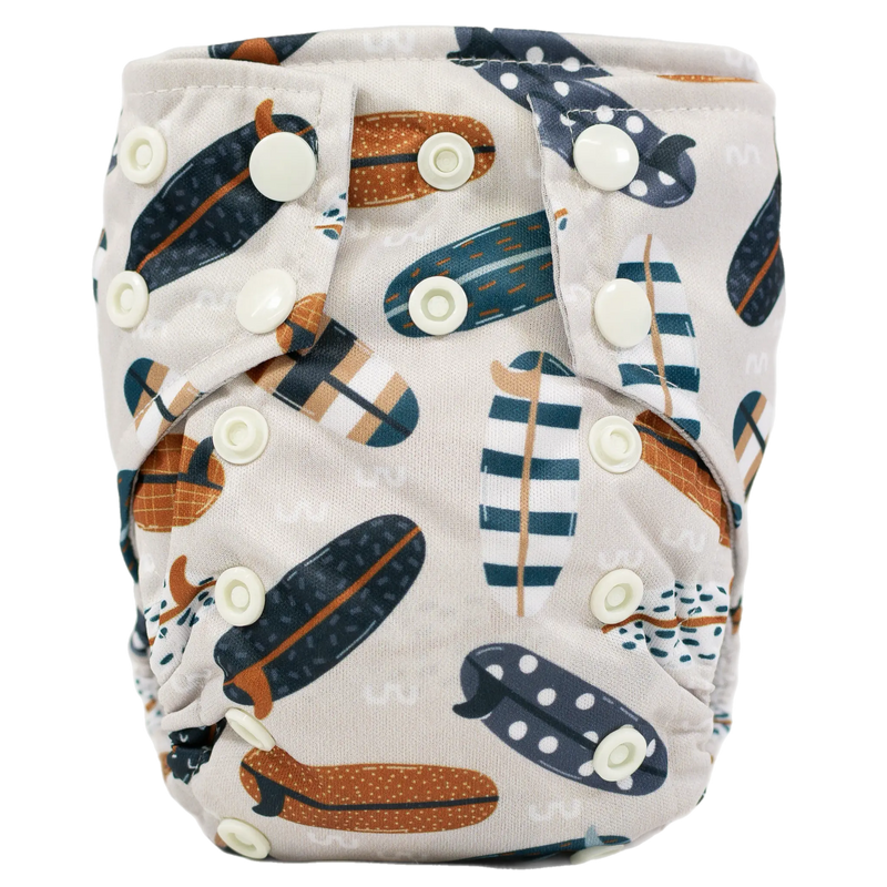 Tiny Tushies Newborn AIO Cloth Diaper with airplane pattern and adjustable snaps.