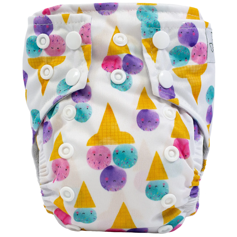 Tiny Tushies Newborn AIO cloth diaper with colorful print and secure snaps.