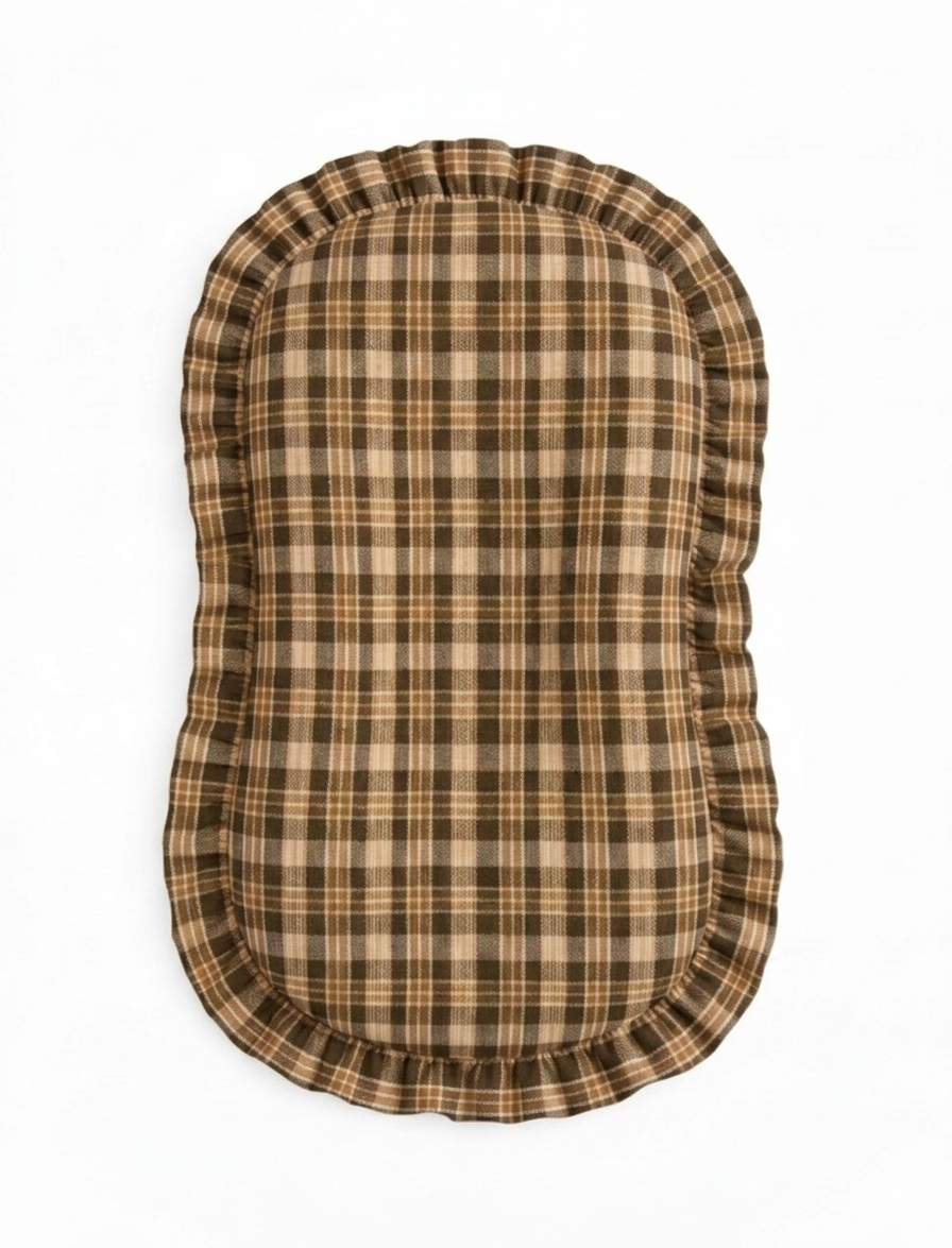 Brown plaid baby lounger cover with a ruffle trim along the top edge