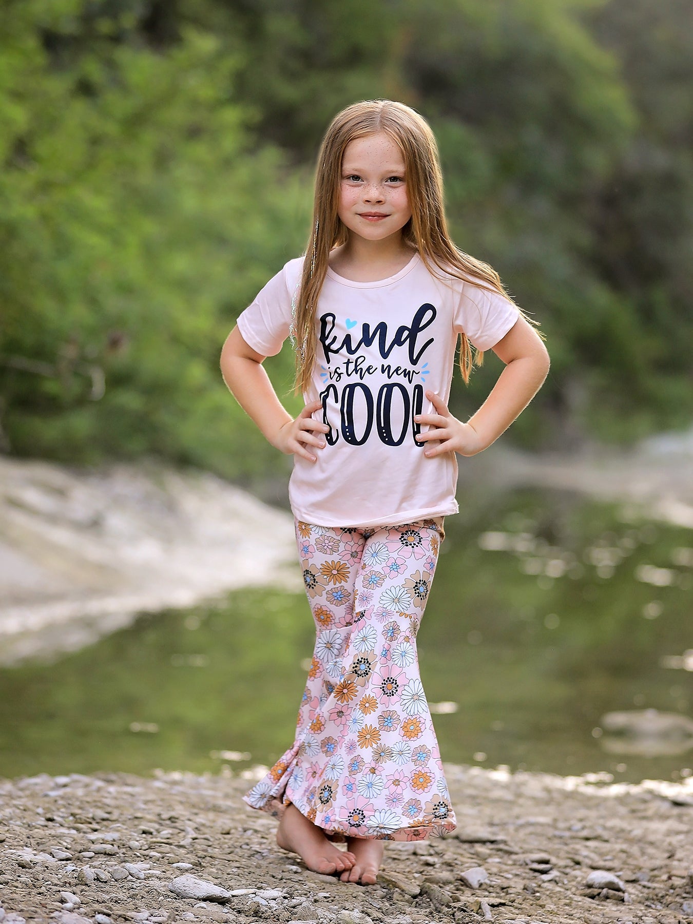 Girls two-piece set with a letter print top and floral pattern pants.