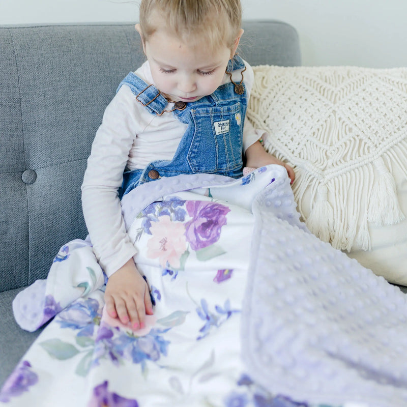 Premium baby and toddler blanket with purple and blush floral pattern, featuring super soft texture, suitable for ages newborn to 4 years.