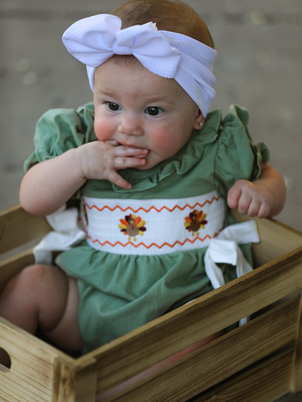 Baby romper with smocked bodice, embroidered chicken design, and contrast collar and trim