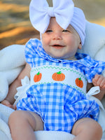 Baby girl romper in blue with pumpkin smock embroidery across the chest for fall and Halloween.