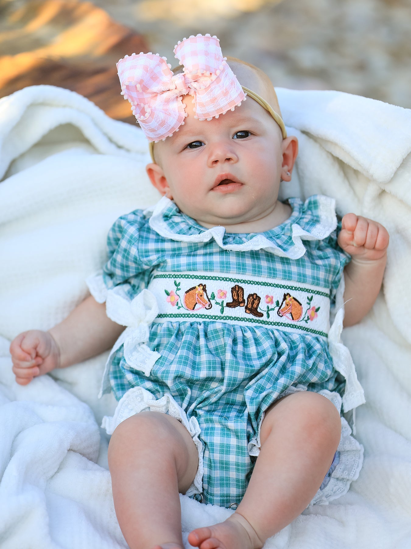 Mint plaid bubble romper with horse and cowboy boot embroidery, lace ruffle trim, puff sleeves and bows.