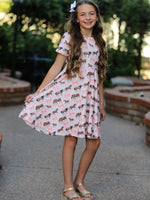 Short-sleeve twirl dress with an all-over western horse print, styled with a matching hair clip.