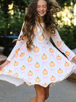 Long sleeve dress with an allover pumpkin and bow print for fall and Halloween.