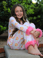 Pajama set with pumpkin and bow print, faux fur trim, button-up long sleeve top and matching pants.