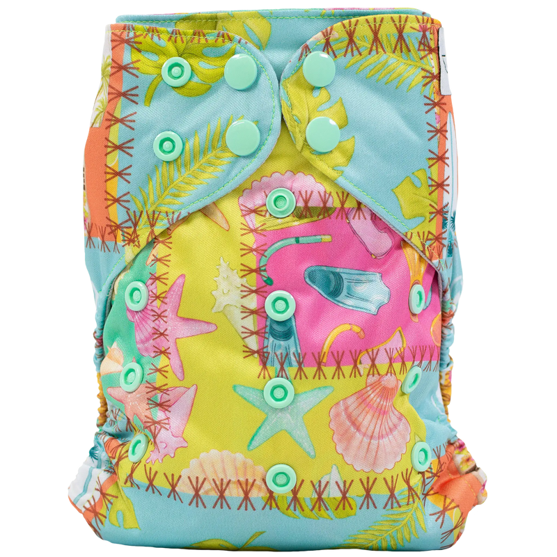 Slim fit pocket cloth diaper with vibrant sea-themed print and adjustable snaps.