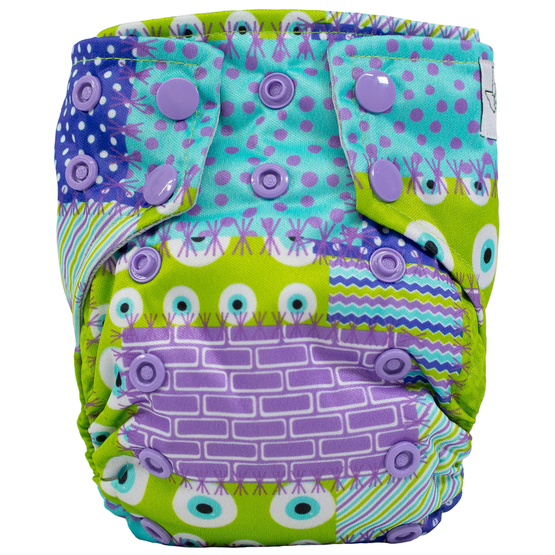 Tiny Tushies Newborn AIO cloth diaper with colorful pattern and adjustable snaps.