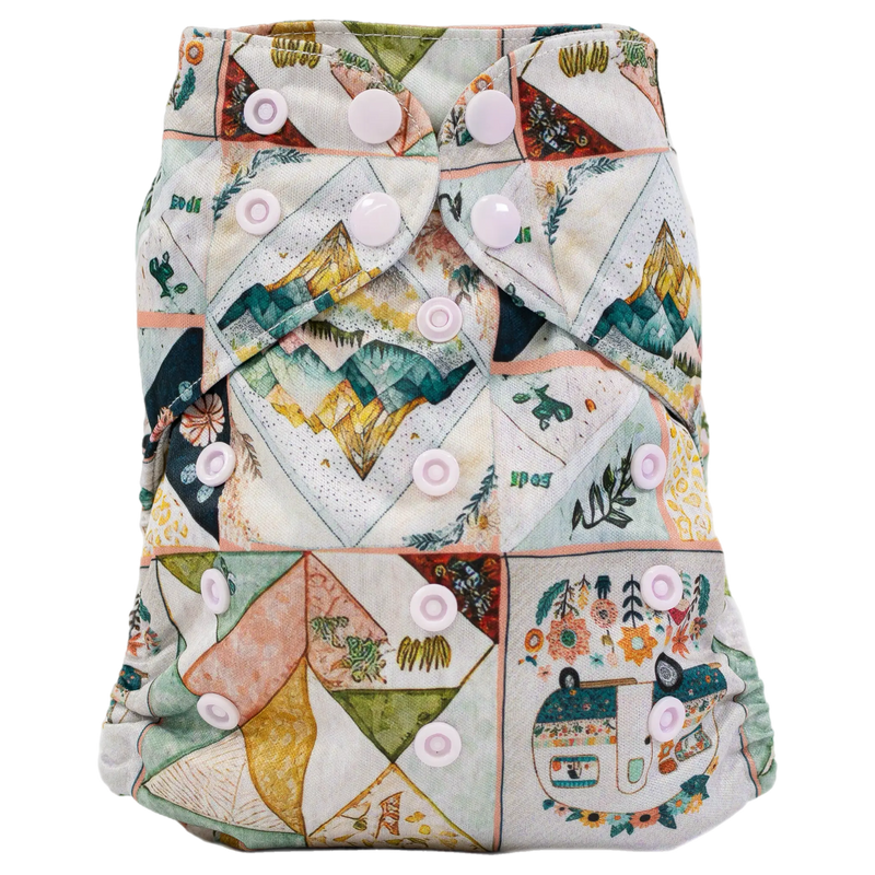Slim fit pocket cloth diaper with colorful printed design and white snaps for customizable sizing.
