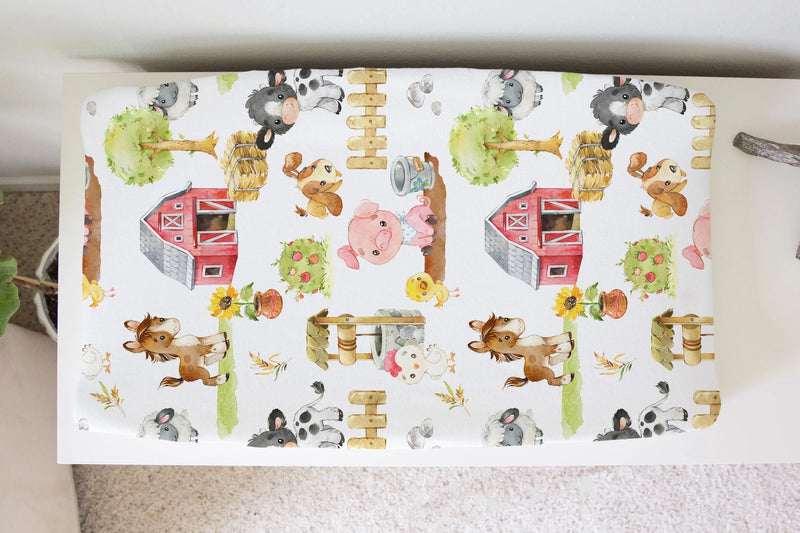 Farm animal changing pad cover with soft, stretchy fabric and playful design.