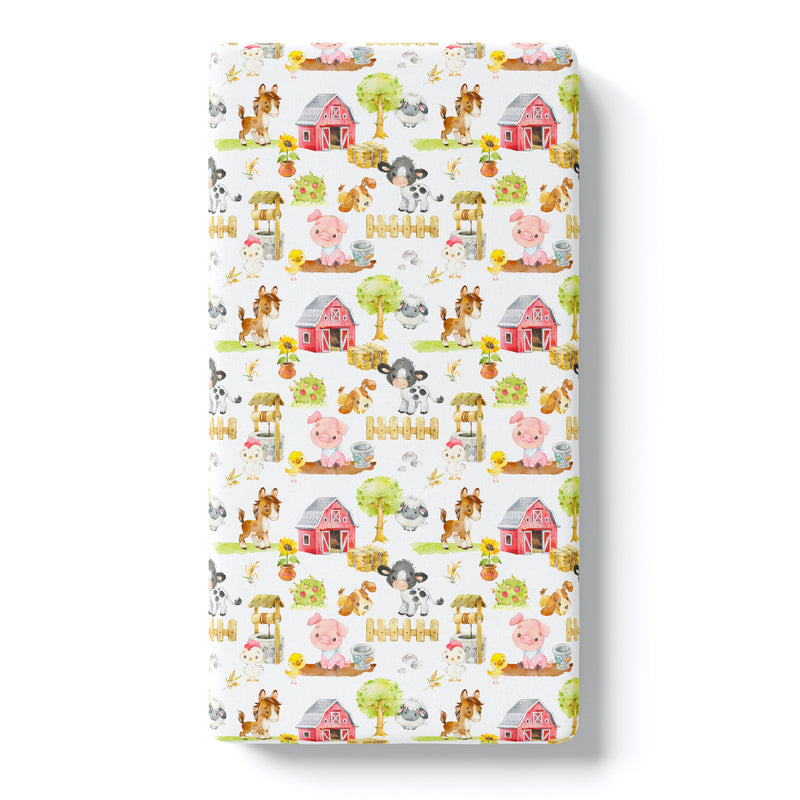 Fitted crib sheet with farm animals pattern on a white background.