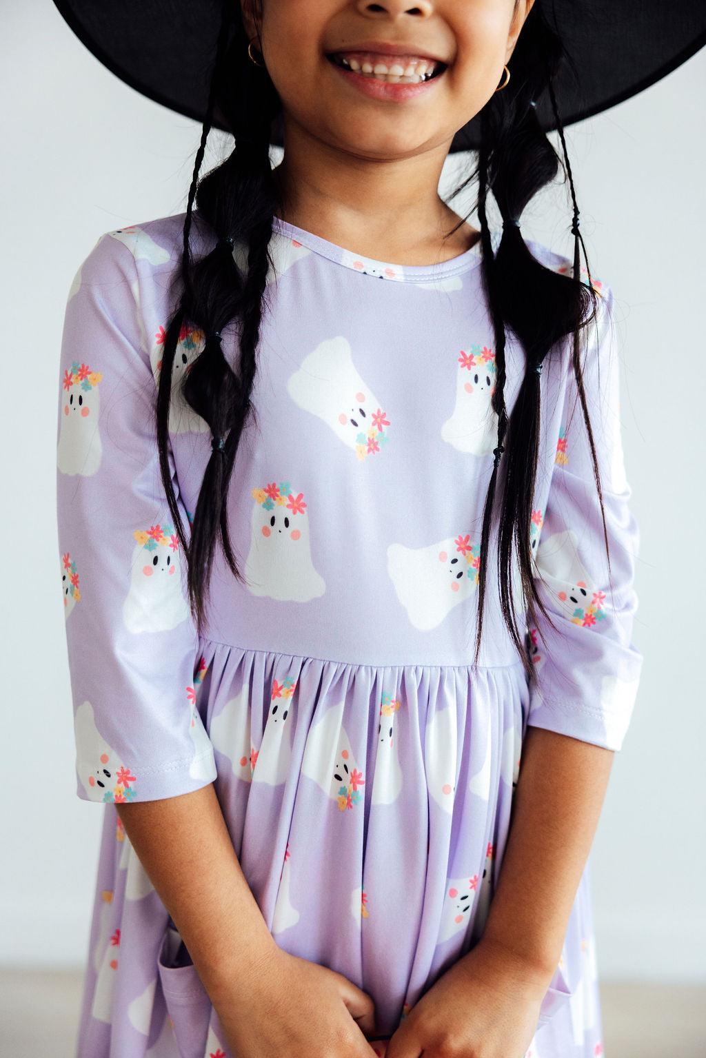 Girls' twirl dress with ghost print, 3/4 sleeves, pockets, and a full skirt for spinning
