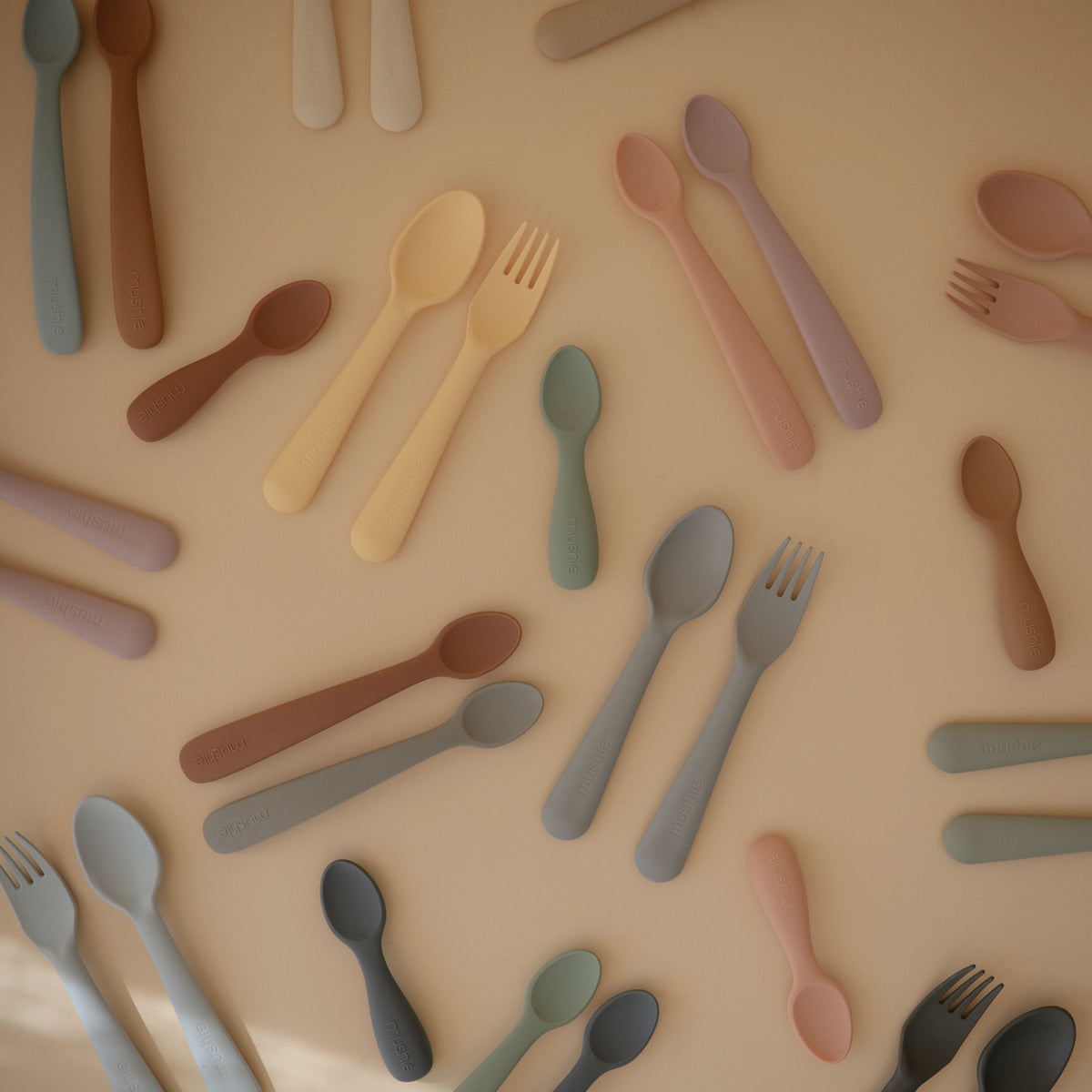 Mushie baby fork and spoon set. Soft-grip toddler feeding utensils.
