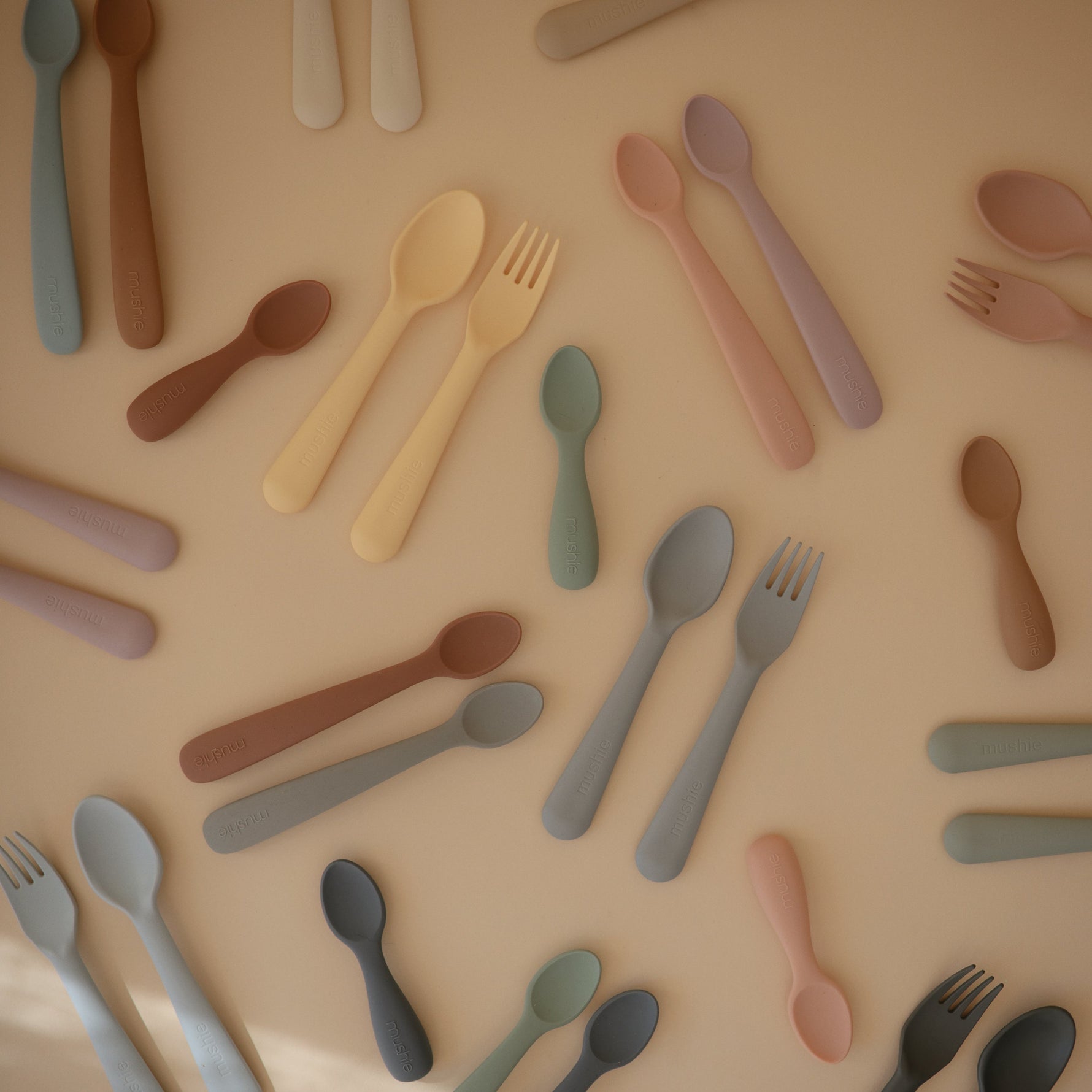 Mushie baby fork and spoon set. Soft-grip toddler feeding utensils.