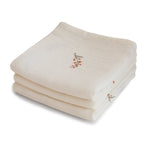 Three folded organic cotton muslin cloths in a stacked set.