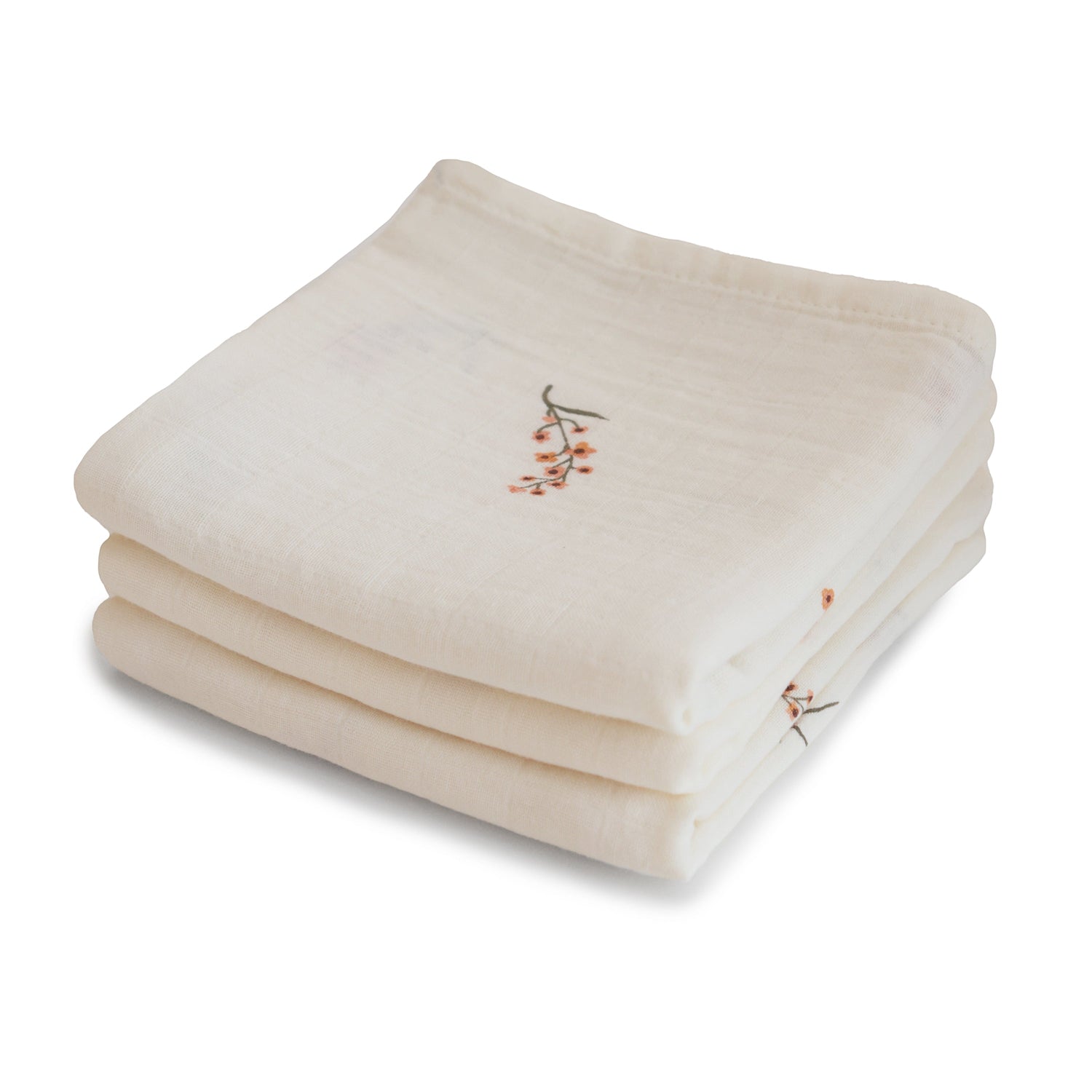 Three folded organic cotton muslin cloths in a stacked set.
