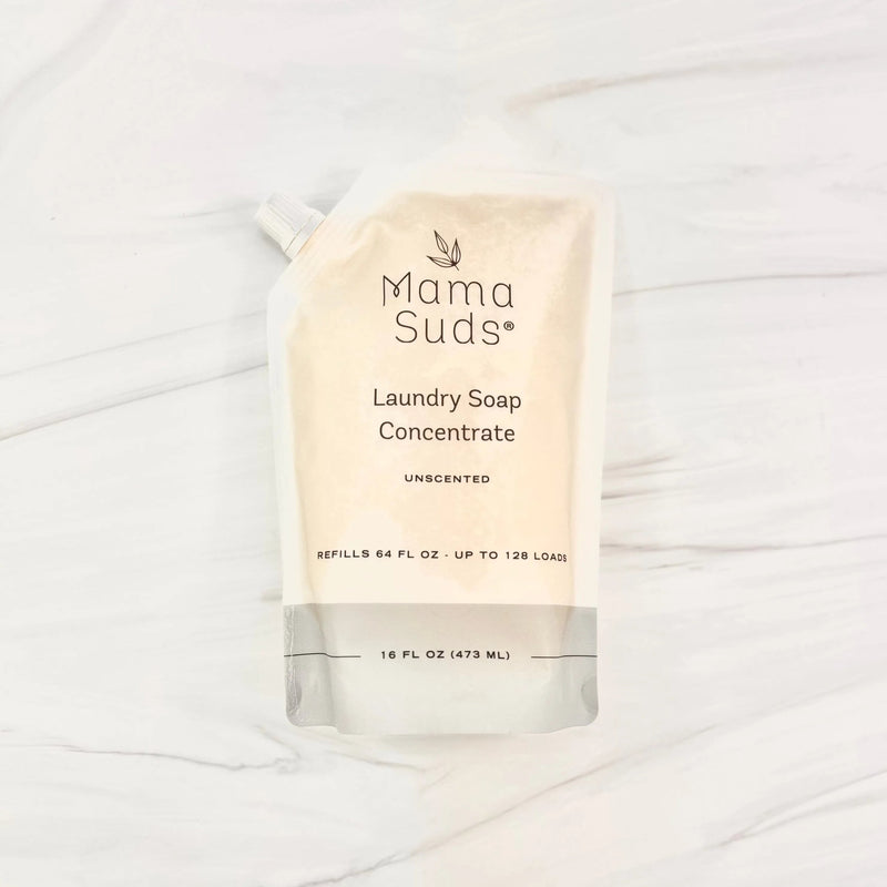 Laundry Soap Concentrate Pouch by MamaSuds on marble surface.