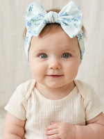 Baby girl headband in blue floral print with a classic bow on a stretchy band
