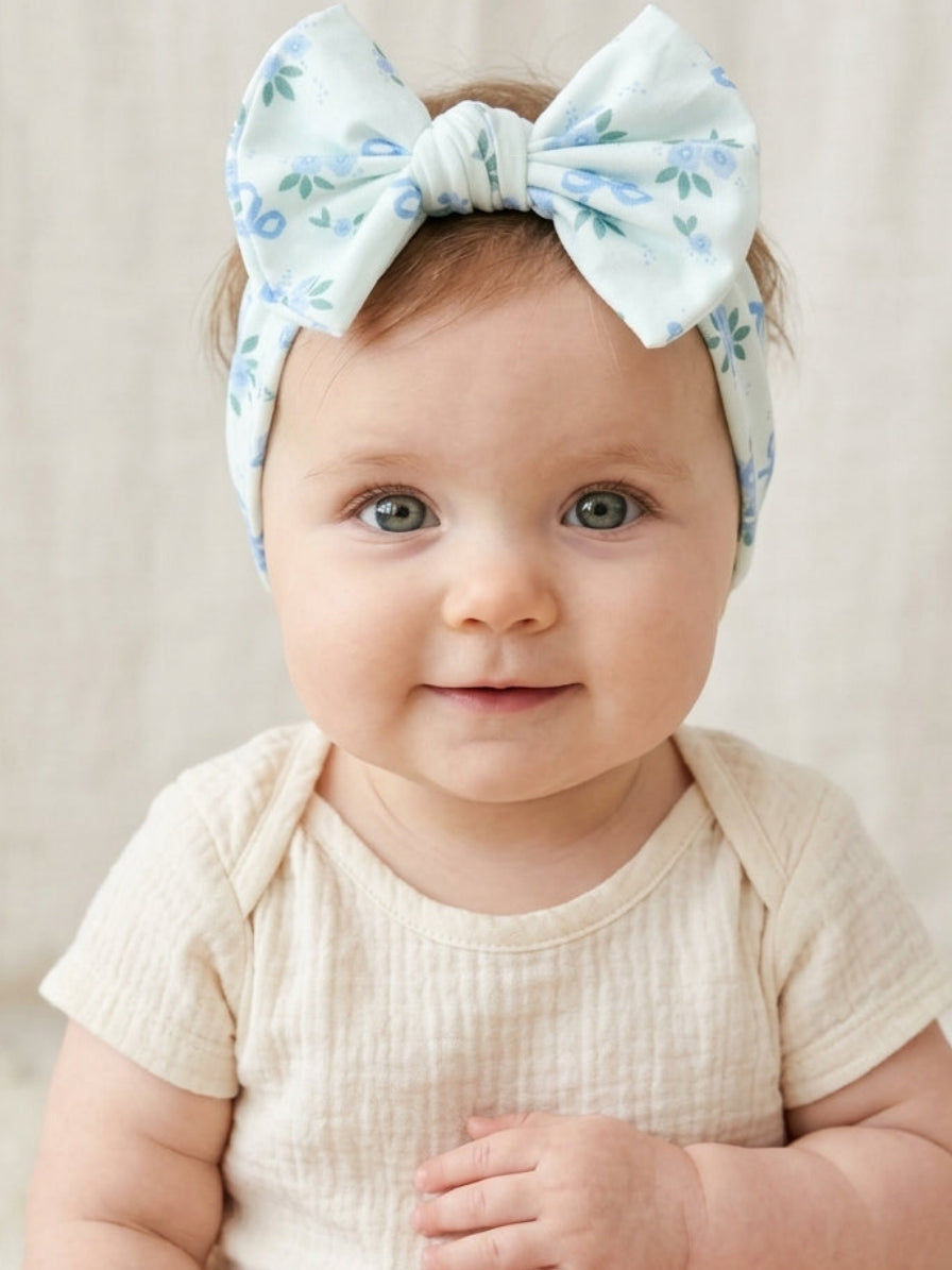 Baby girl headband in blue floral print with a classic bow on a stretchy band